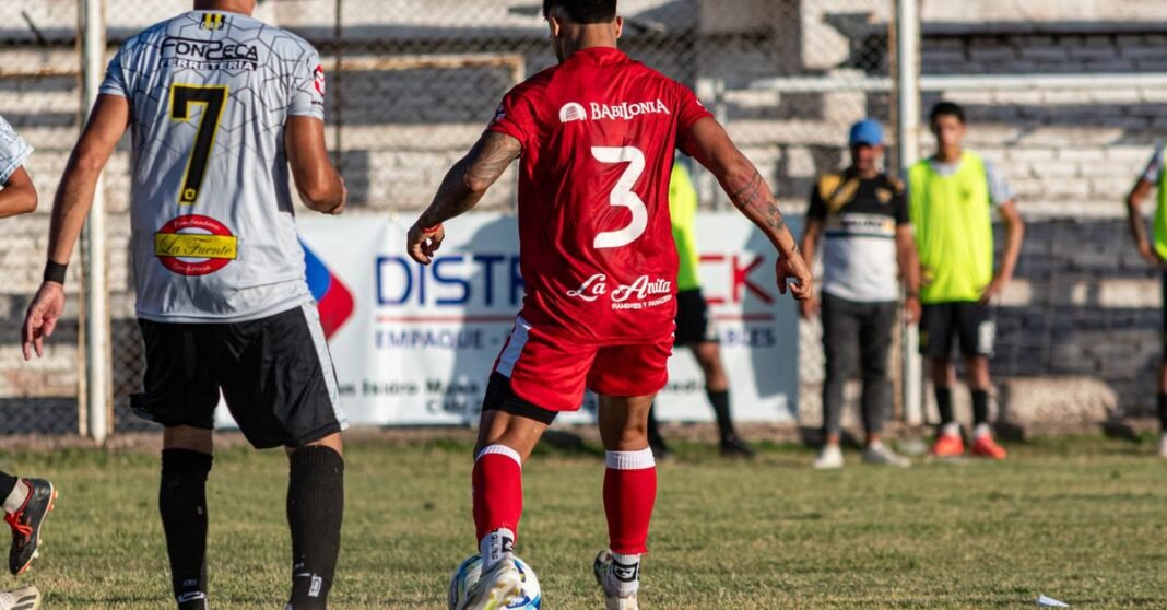 Soccer players in a dynamic match, showcasing teamwork and competition.