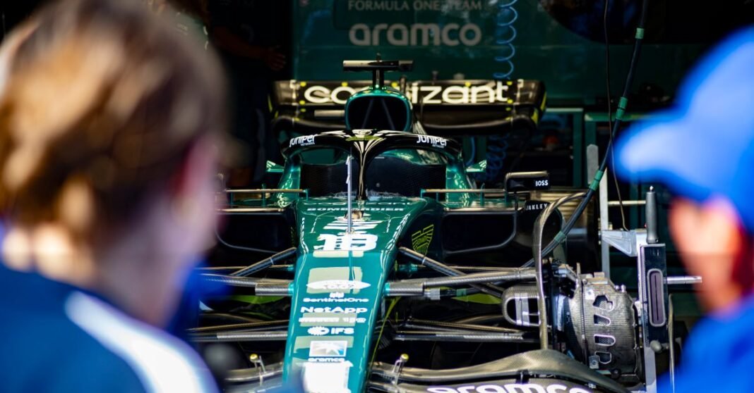 Aston Martin Formula 1 race car being prepared in the team garage before competition.