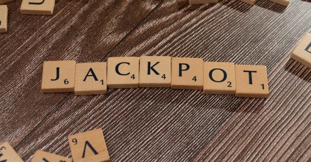 Wooden letter tiles spelling 'JACKPOT' on a textured wooden surface, representing winning or success.