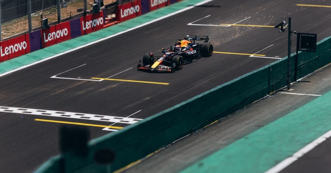 A Formula 1 car speeds down the track during a race, showcasing high performance.