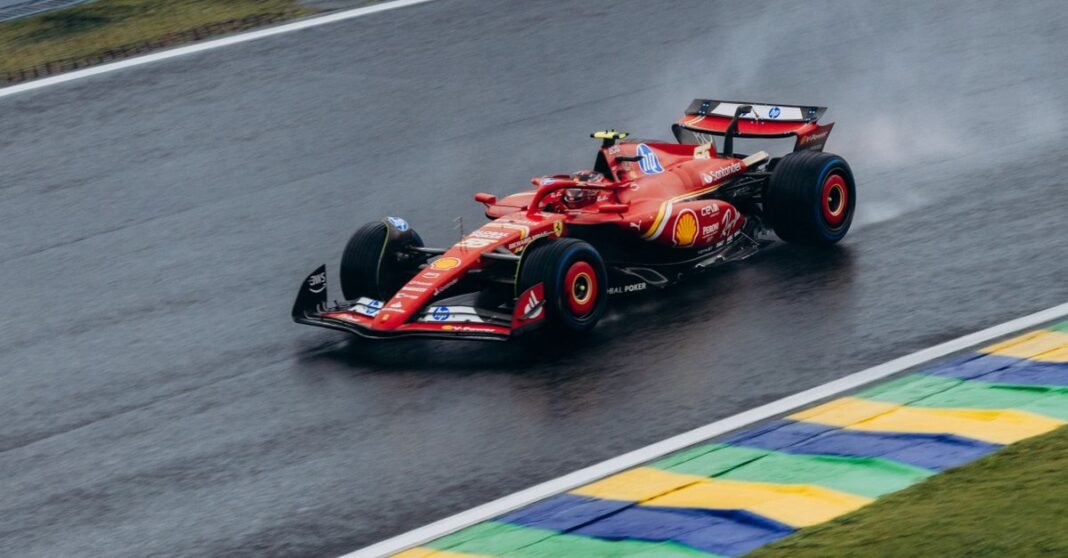 Ferrari Formula 1 car speeding through a wet track at Interlagos, capturing dynamic racing action.