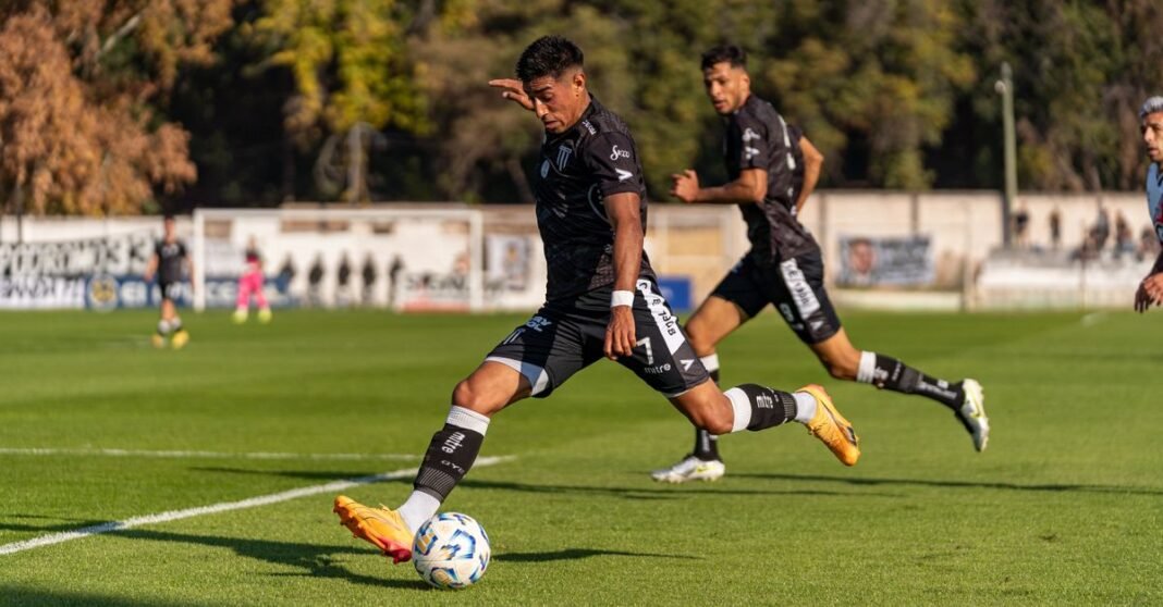 Dynamic action shot of footballers on the field during an outdoor game, showcasing sportsmanship and movement.