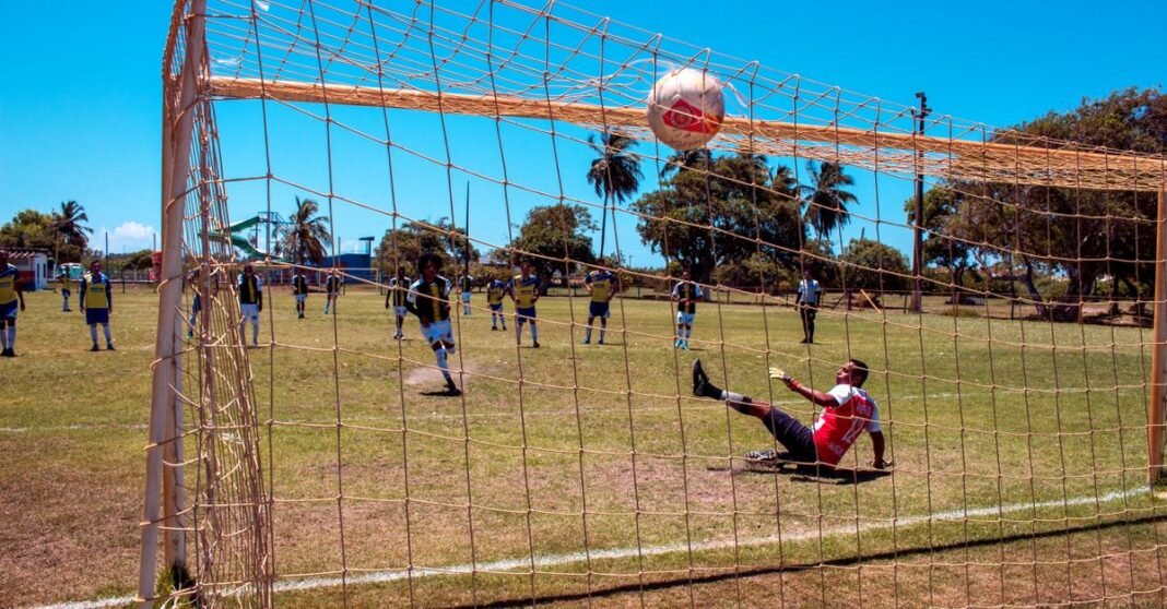 A thrilling moment during a soccer match in Aracaju, Brazil with a goalkeeper missing a challenging save.