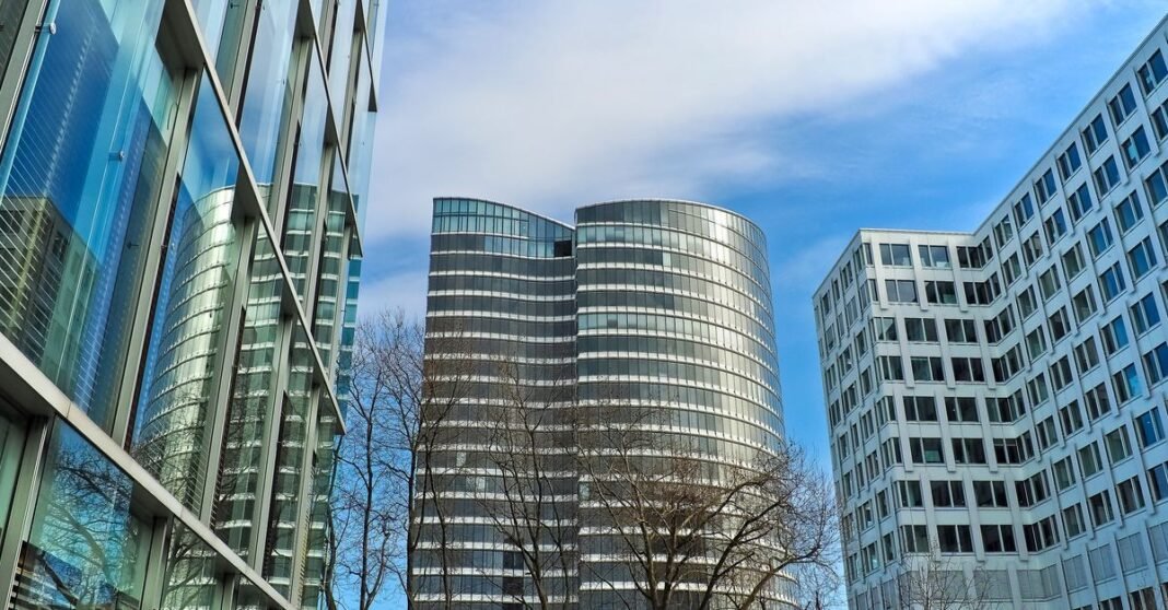 A striking view of modern skyscrapers against a clear blue sky, showcasing contemporary architectural design.