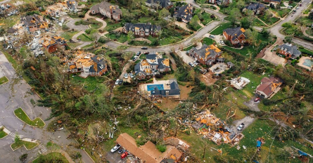 Aerial view of small settlement with destroyed houses and bent uprooted trees after hurricane