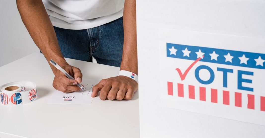 Close-up of man voting at ballot box, emphasizing democratic participation.
