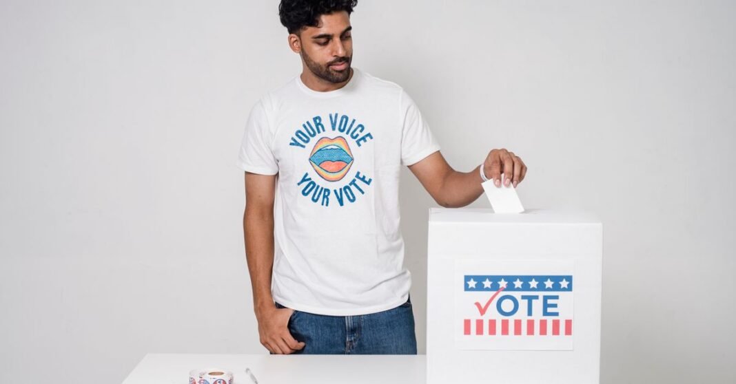 Young man casting a vote into a ballot box on a white background promoting democracy.