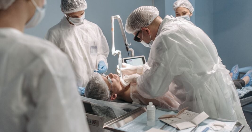 Team of surgeons conducting surgery with precision in a modern operating room setting.