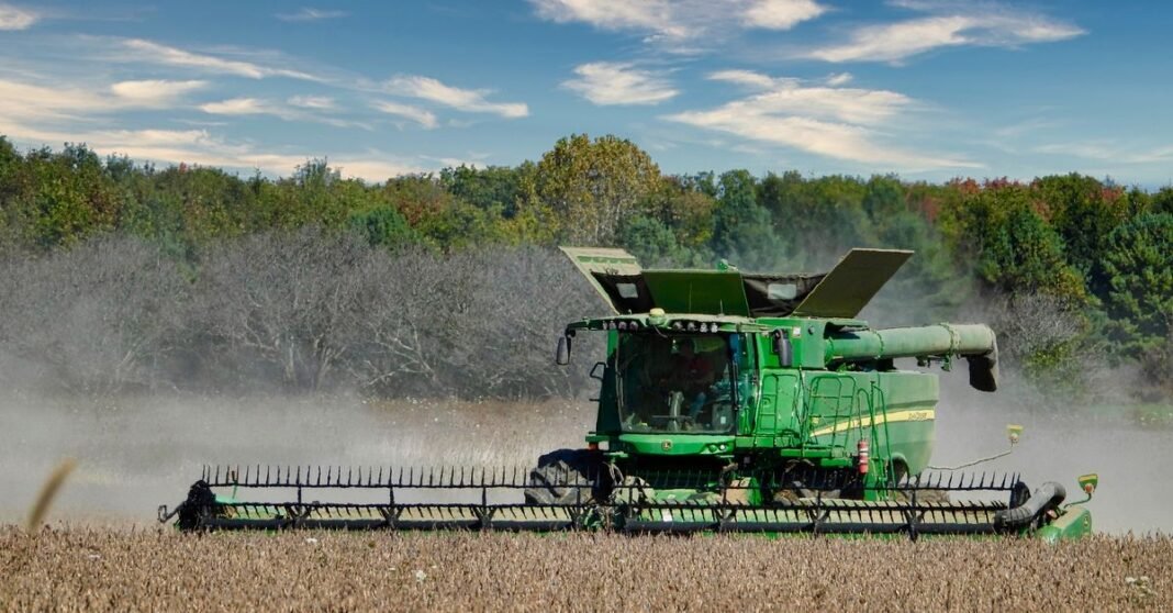 Combine harvester working in a soybean field in Ontario, Canada.